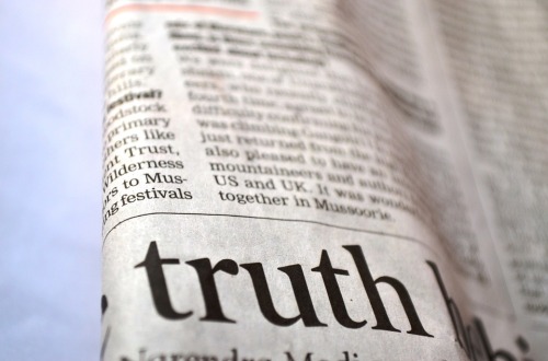 Newspaper folded to highlight the word 'truth'